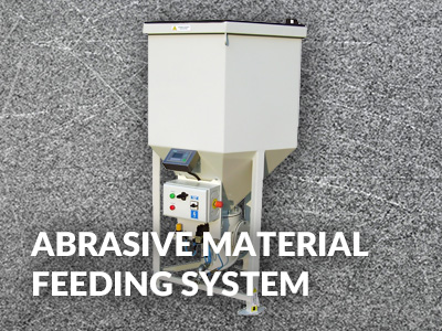 Abrasive material feeding system